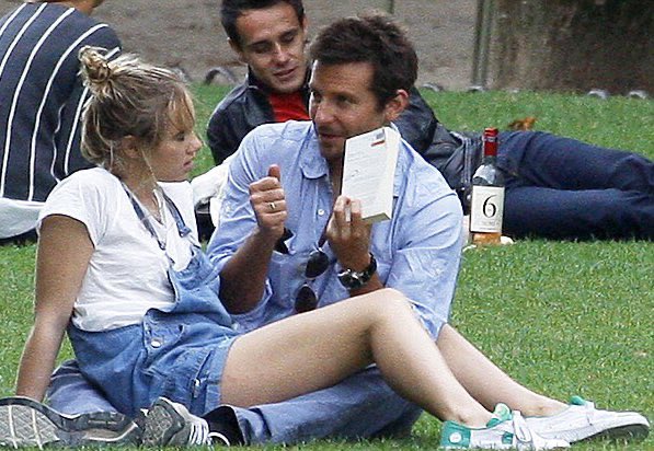 rosielanners's tweet photo. I think about these paparazzi pics of bradley cooper (38) reading lolita to a bored suki waterhouse (21) in a parisian park like, at least once a week https://t.co/Xb0tHBFwqq