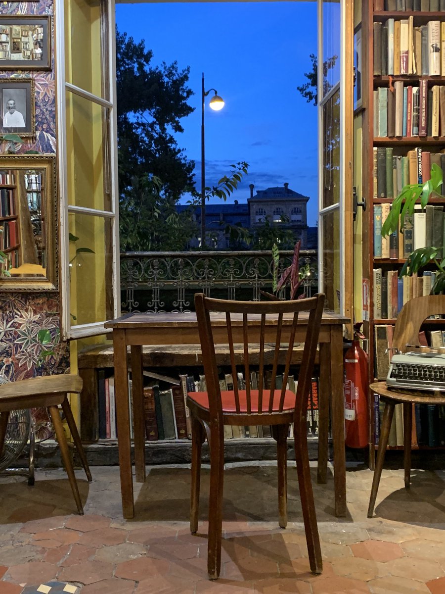 Upstairs writer’s room at Shakespeare &amp; Company — windows open to the Paris night