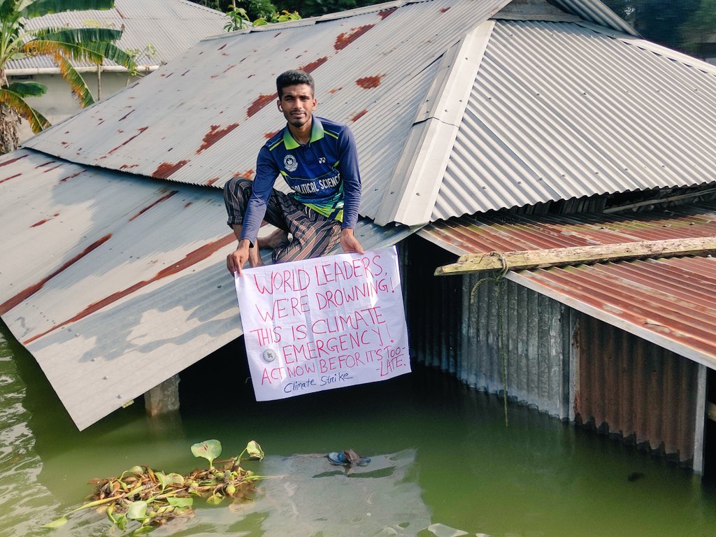 NayonSorkarBD's tweet photo. We’re Drowning &amp; World leaders are watching.

#ClimateStrike over a #flooded house in Sylhet of #Bangladesh

More than 3M people have been rendered homeless &amp; as many as 
5M houses have been destroyed in the recent #floods in #Sylhet

#ClimateEmergency #ActNow
#ClimateCrisis #SFB https://t.co/G8KCmWfWTA