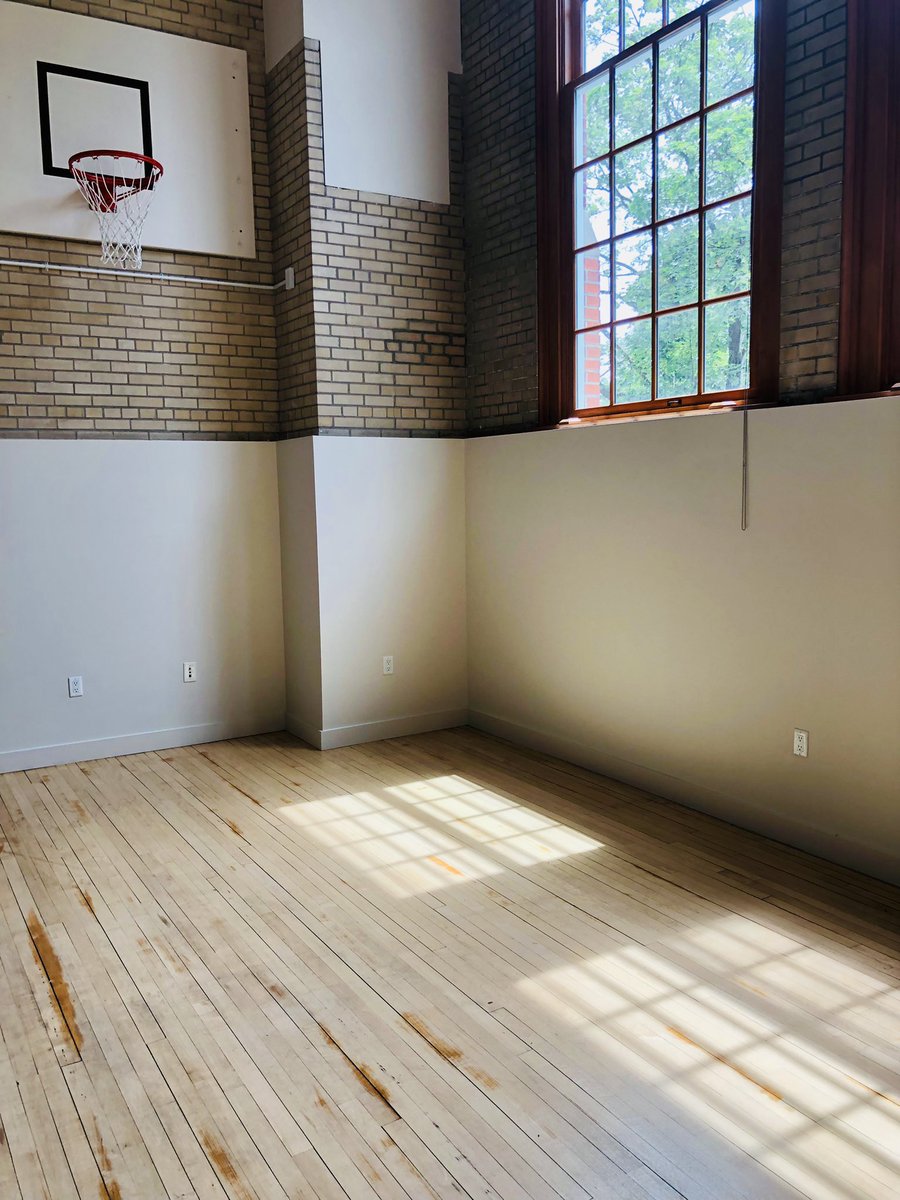 My new apartment is in a renovated elementary school. Mine is in what used to be the gym, and the original basketball hoop is in the living room. Still waiting for my movers to arrive and unload my stuff, but maybe I should just leave it empty and host some games 🤔? #ballislife