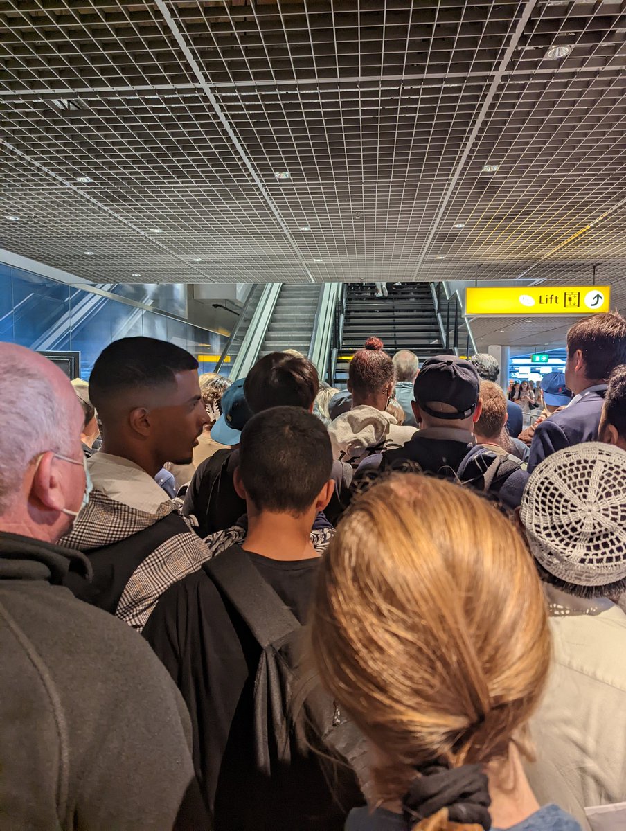 jdarcy_derby's tweet photo. @Schiphol seriously need to have better crowd control measures. Penned up like cattle before the stairs then allowing a stampede up. This could have been a very dangerous situation. https://t.co/maPQXYKqWA