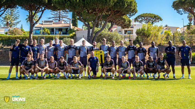 Burton Albion's first team squad and staff pose with a signed shirt at Browns Sports Resort in Vilamoura following our week-long pre-season camp there