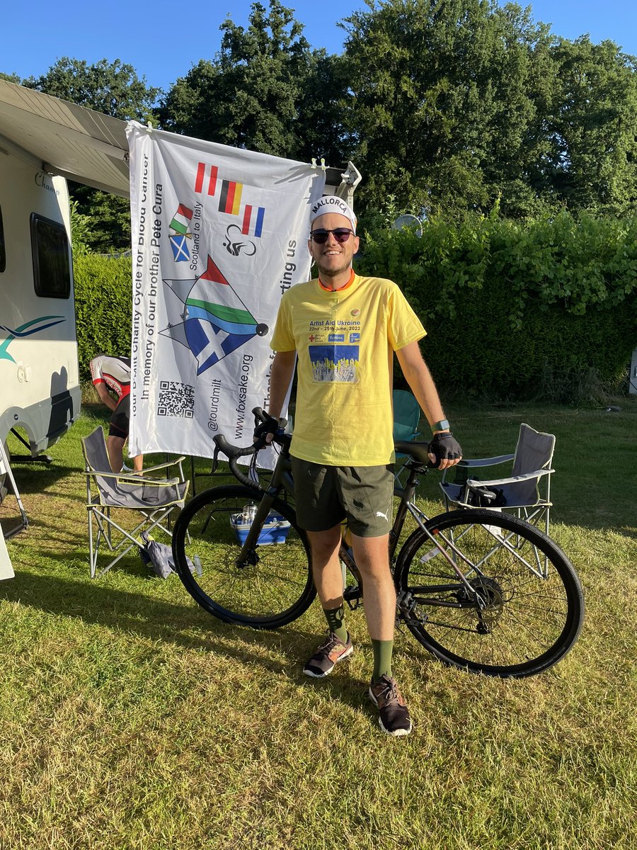 tourdmilt's tweet photo. Also, it was Jamie’s last day cycling before he rejoins us in Italy for the final week cycling. He says he will miss causing mischief in the campsites. He is repping his Ukrainian #artistaidukraine today. #foxsake https://t.co/8rX2cu0O5w
