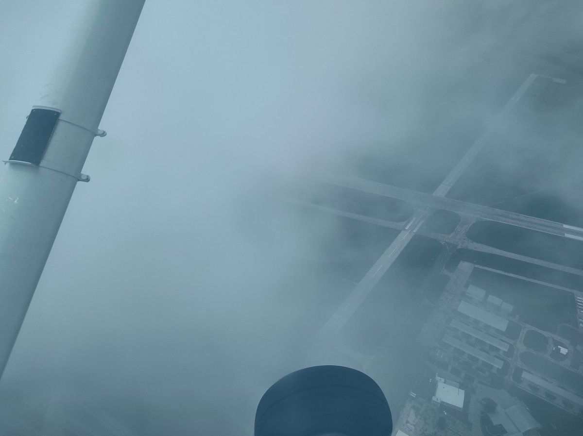SheriffWalrus's tweet photo. Here's another picture from the flight, an airport peeking through the clouds https://t.co/tWp5dobMcD