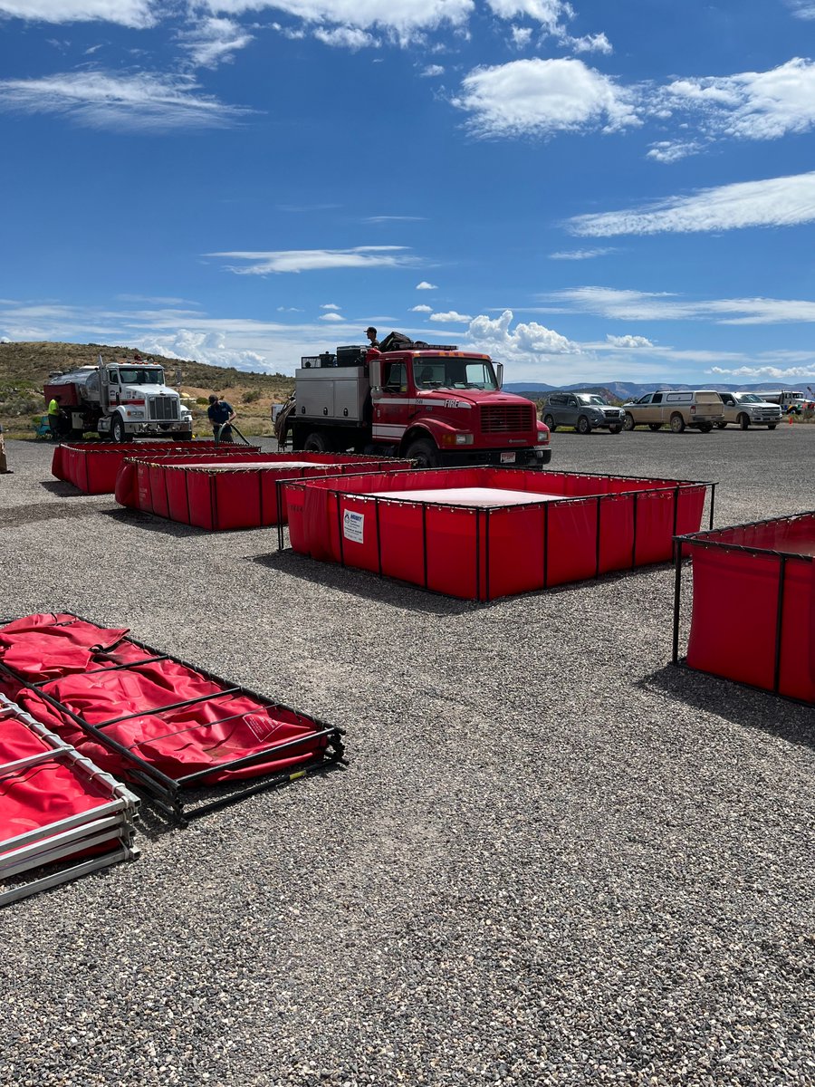 usfsdnf's tweet photo. As crews and equipment head home from the #LeftForkFire, fire managers take action to control invasive species. These fold-a-tanks with chemicals are used to wash the water handling equipment, as part of a decontamination process to stop the spread of any disease to other forests https://t.co/mKdEwwgki6