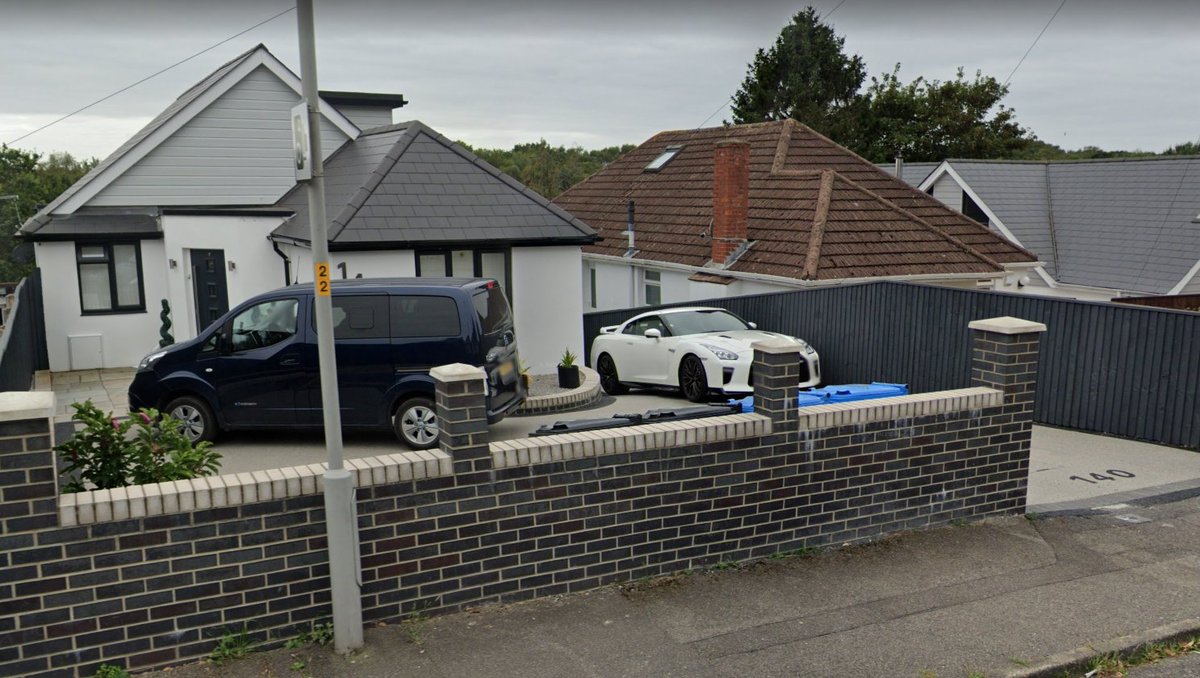 Cars_SV's tweet photo. A very interesting choice for a Nissan themed 2-car garage (maybe @itsvantime would take it?) with a lovely white R35 GT-R joining the not very common passenger version of the e-NV200, called Evalia 

Poole, England - September 2021 #StreetViewCars #SV_Supercars #SV_Vans https://t.co/CnftesQSlr