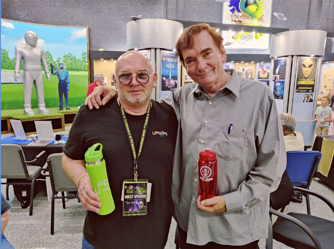 ufoman59's tweet photo. Thom Reed and Travis Walton at the Roswell Museum....Travis is holding a UFO MAN Red Water Bottle! #ufotwitter #uaptwitter #thomreed #traviswalton #roswellmuseum #2022ufofestival #RoswellNM #UFOMAN https://t.co/zPqctnl1ha