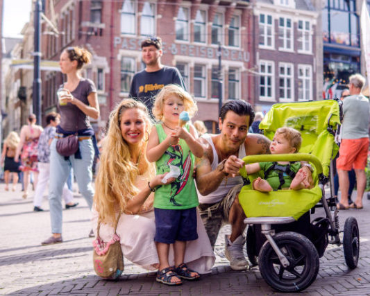NftDoh's tweet photo. When traveling in The Hague, I met up with a lovely family, who especially like to be backpackers, and after giving birth, they still carry their babies around the world. Later, I took a photo of them together, which I liked very much.hg https://t.co/yIRLkyNiDO