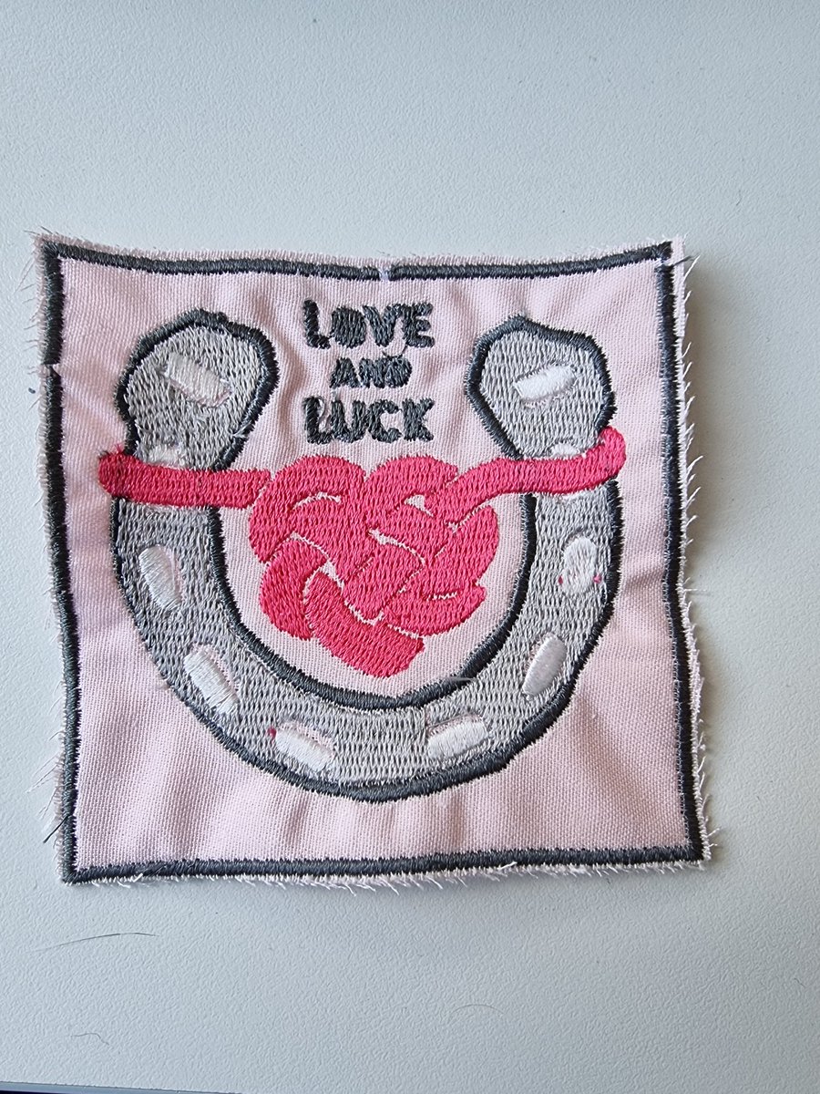 First attempt at a <a href="/LoveLuckPodcast/">Love & Luck Podcast</a> patch, as well as first time with an auto-embroiderer (which was not as auto as I first thought!) The horseshoe colors are reversed from my error, there were *so* many broken threads, but otherwise I'm pretty pleased with the prototype!