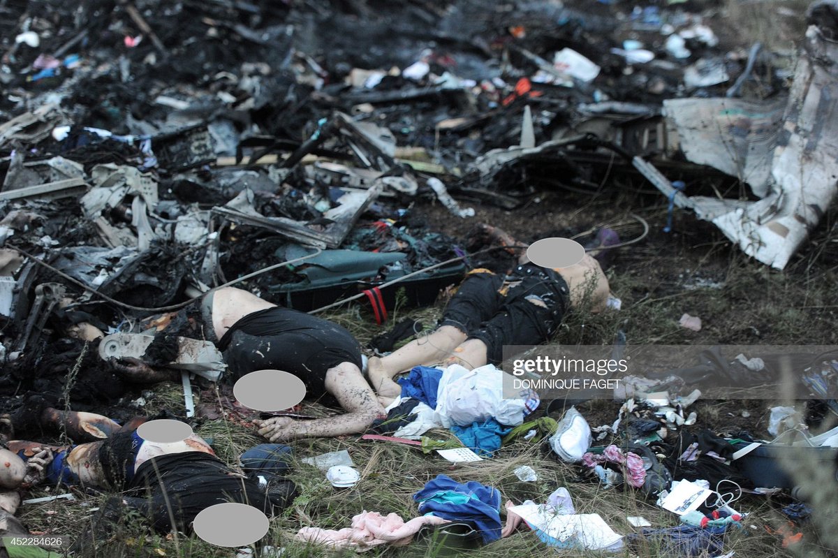 Disturbing picture from the MH17 crash site, July 17, 2014, when 298 people were murdered by Russians who fired an anti-aircraft missile at the Malaysian Airlines aircraft over SE Ukraine Video shows the Russians looted the dead passengers shortly after crashing Don't look away