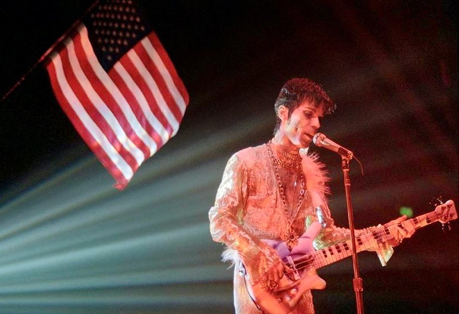 Prince playing his Warwick one-eyed bass at Wembley Arena in London in March 1995. Photo by Brian Rasic. #Prince