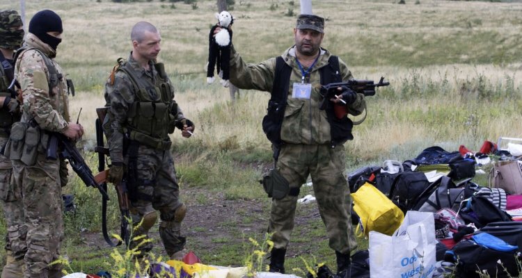 visegrad24's tweet photo. Russians celebrating in front of the wreckage of MH17 after shooting it down over Eastern Ukraine on July 17th 2014.

298 civilians were killed by the missile that had been provided by the Russian Army. https://t.co/zqe7rcR965