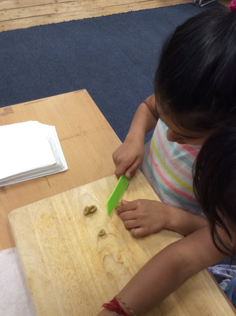 We are making our pizza today! We are cutting and grating our ingredients.