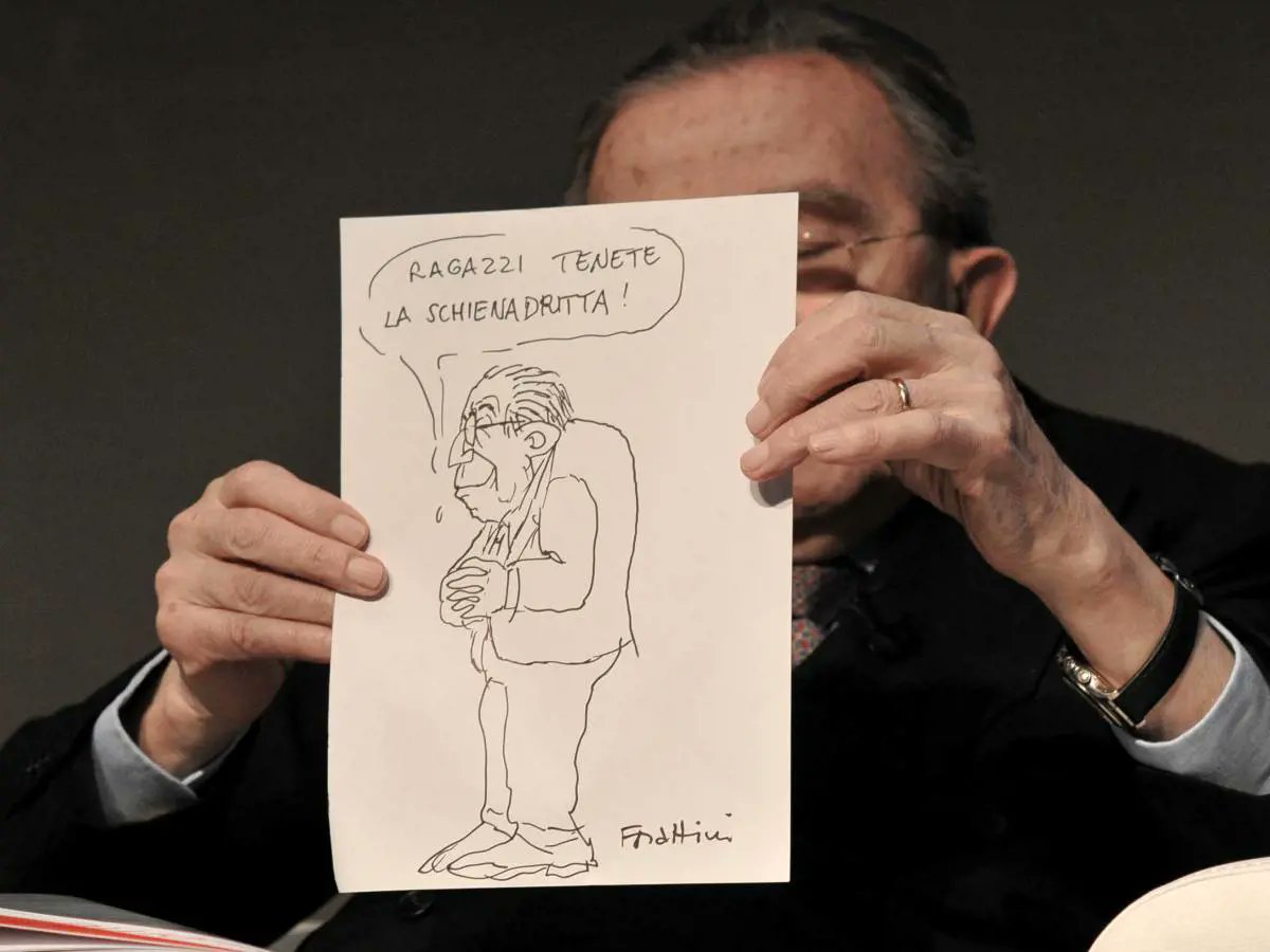 Former PM Giulio Andreotti holds a satirical cartoon of himself, drawn by cartoonist Giorgio Forattini.

The cartoon says "Guys, keep your backs straight!", a joking reference to Andreotti's humped back.