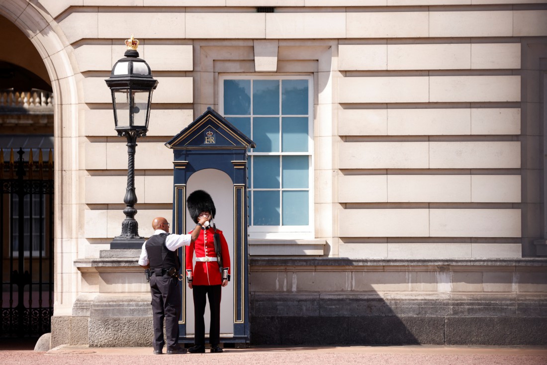 A member of the Queen's Guard receives water to drink during the hot weather, outside Buckingham Palace

photo by John Sibley/Reuters