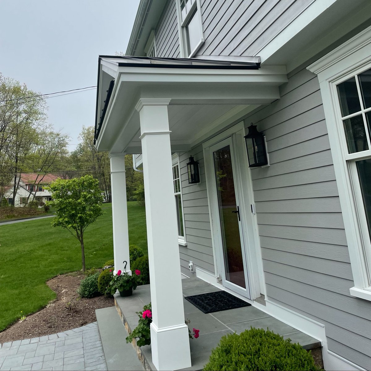 BurrRSW's tweet photo. Custom porticos are part of our forte here at Burr.  Here in Danbury this family opted for 8" square columns and a Dark Bronze metal roof to contrast the asphalt roof on the rest of the house. #customportico #metalroofaccent #portico #newenglandhome #exteriorrenovation #cthomes https://t.co/YMlsi9QvvR