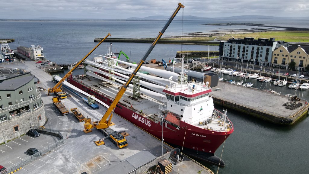 Another angle of the tall cranes, lifting the really long propellers onto an even longer truck transporting them from the big ship