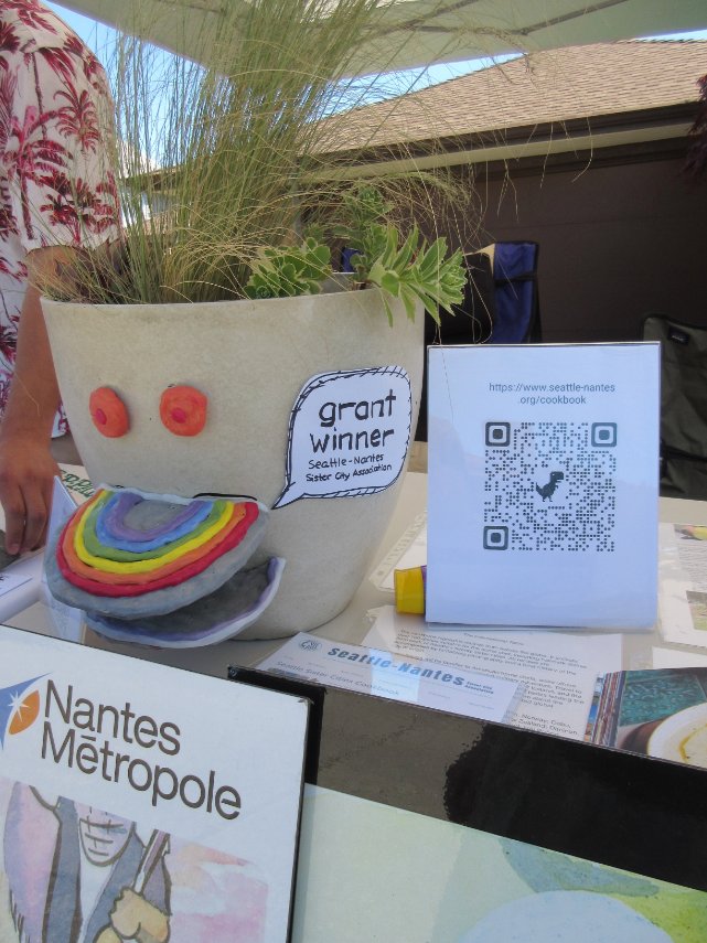 SeattleNantes's tweet photo. Since SNSCA was a recipient of the West Seattle Garden Tour Grant, we had a table up during this year's tour in order to share with goers about how we used the grant money in our Nantes Park beautification student tile project. https://t.co/S5lGTMZt1k