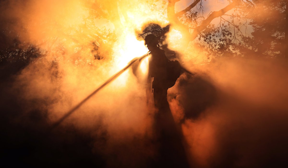 kentphotos's tweet photo. About five minutes after making video of the same scene, the light, well, became super impressive as Ron Buras of Hopland @CALFIRE_MEU mops up the remains of a barn that burned during the #MerlinFire Wednesday at sunset. @NorthBayNews #SonomaCounty #FireSeason #itsthelight https://t.co/RWSLS64sVR