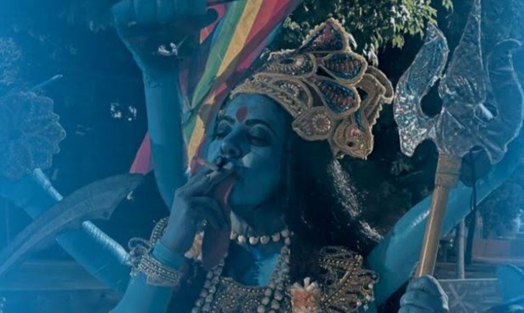 _DevanshRawat_'s tweet photo. #KaaliPosterRow 

Stop denigration of Hindu Gods
Hindu religious icons should not be used in such insensitive manner.BJP demands Mahua Moitra's arrest.The poster depicts a woman dressed as a Goddess #kaali and seen smoking.the character held a trident and the LGBTQ flag https://t.co/rksuZWvk8I