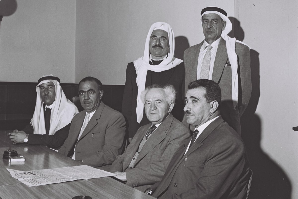 نواب عرب ودروز في الكنيست، مع رئيس وزراء إسرائيل، ومؤسسها، دافيد بن غوريون، عام 1959.
 فريتز كوهين …