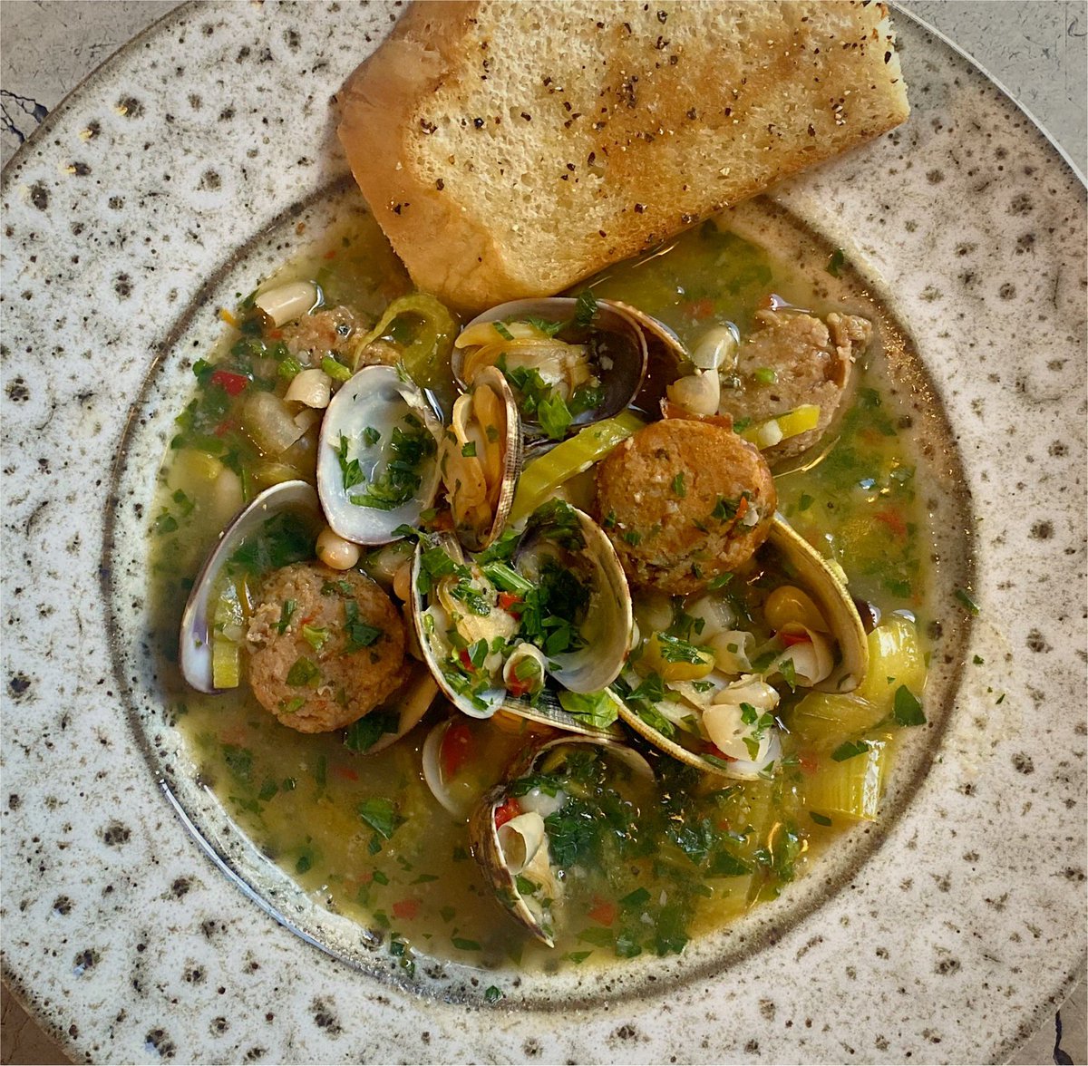 Fresh clams, homemade chorizo, fennel and white bean cassoulet, garlic crouton
