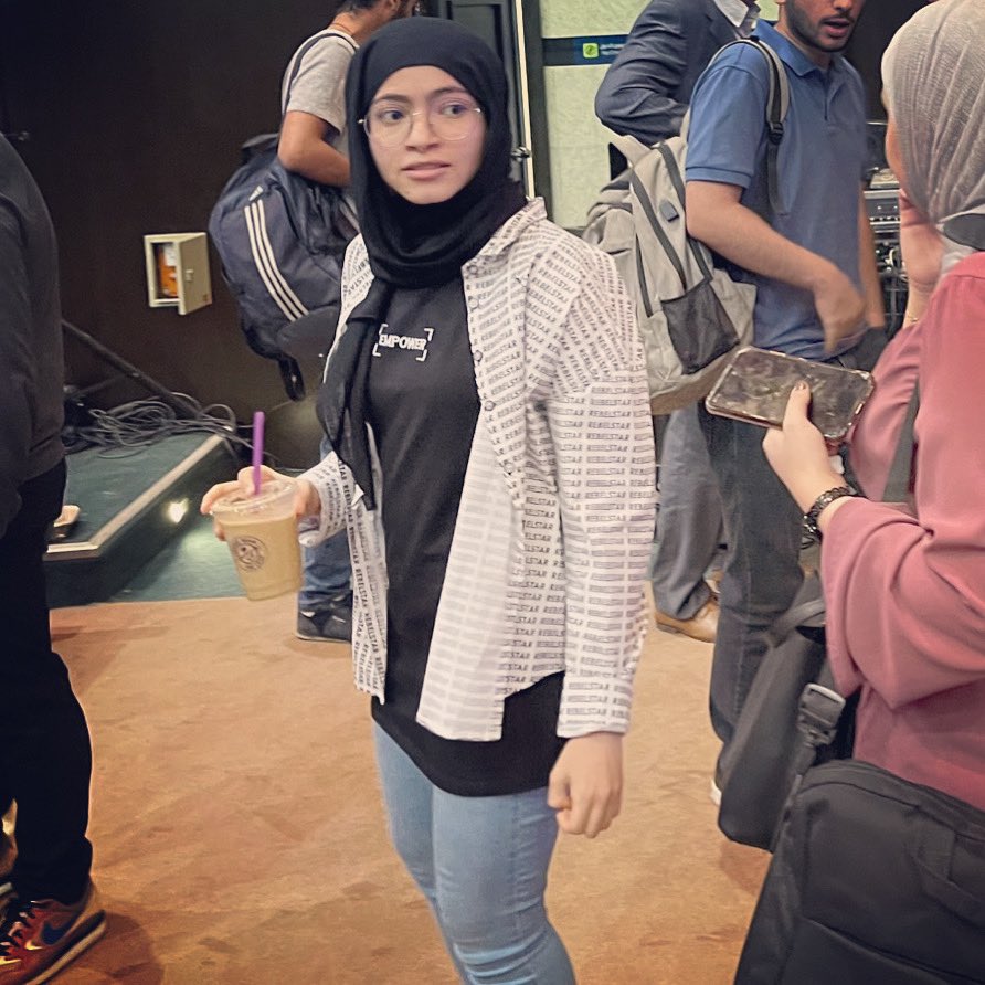 Gotta love this photo taken of me,
completely unaware, wearing a t-shirt that says
EMPOWER, under a shirt that says REBELSTAR, and
holding an iced latte.
If this doesn't sum me up I don't know what does.
LOVED empowering students around MENA
this week. #Serverless #ShababsOnTour