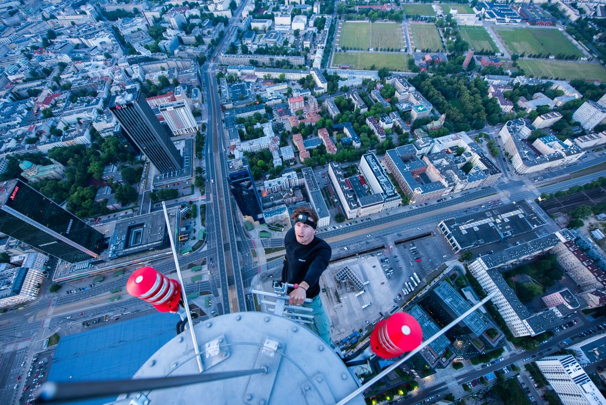 I was climbing on the spire of the tallest building in the European Union.

What do you think, how tall is this building? Reply in meters or feet.