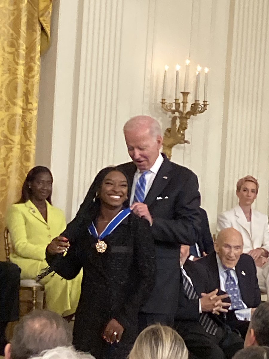 AamerISmad's tweet photo. Big smile on Simone Biles as she receives the Presidential Medal of Freedom from President Joe Biden https://t.co/qY4ToHMztV