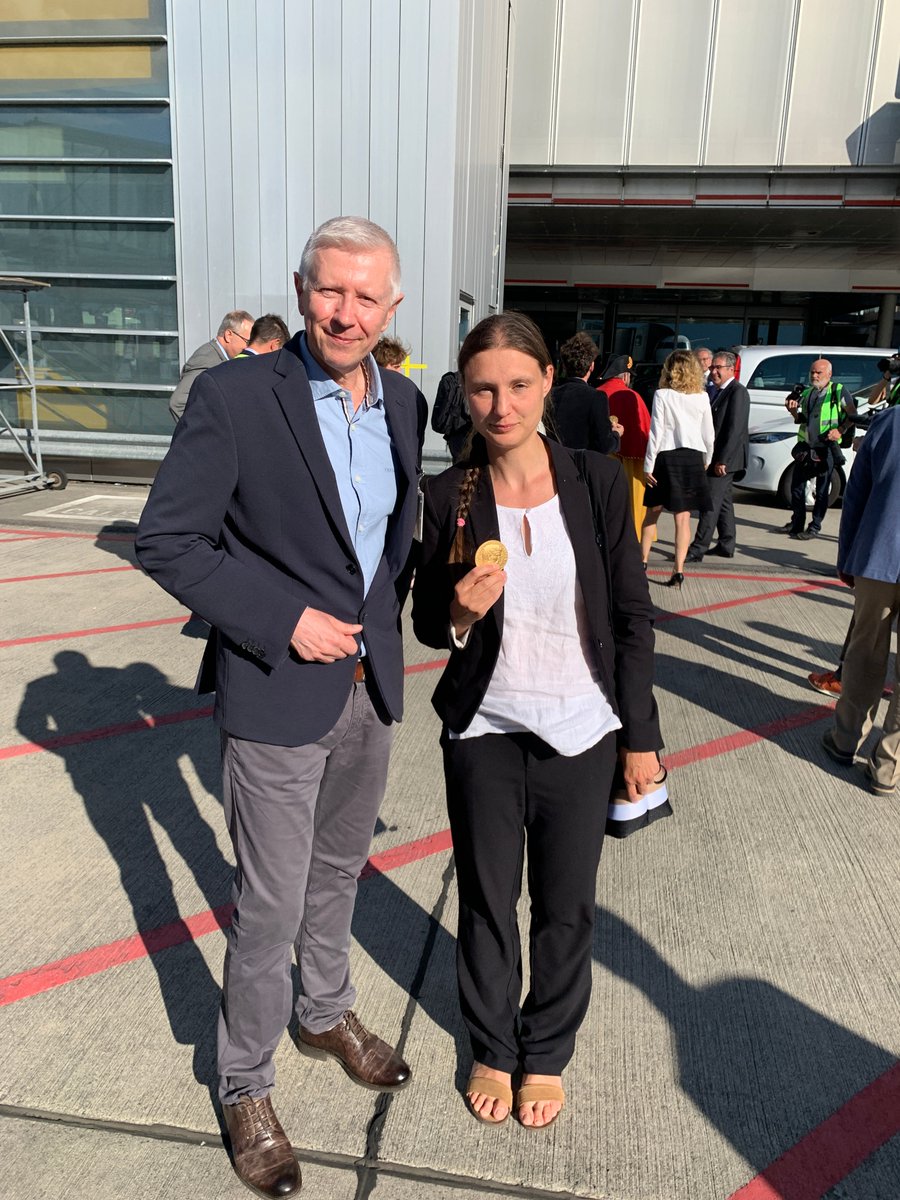 Maryna Viazovska holding her #FieldsMedal with Paul Dyson (Dean of SB) on the tarmac at Geneva airport on Thursday evening.