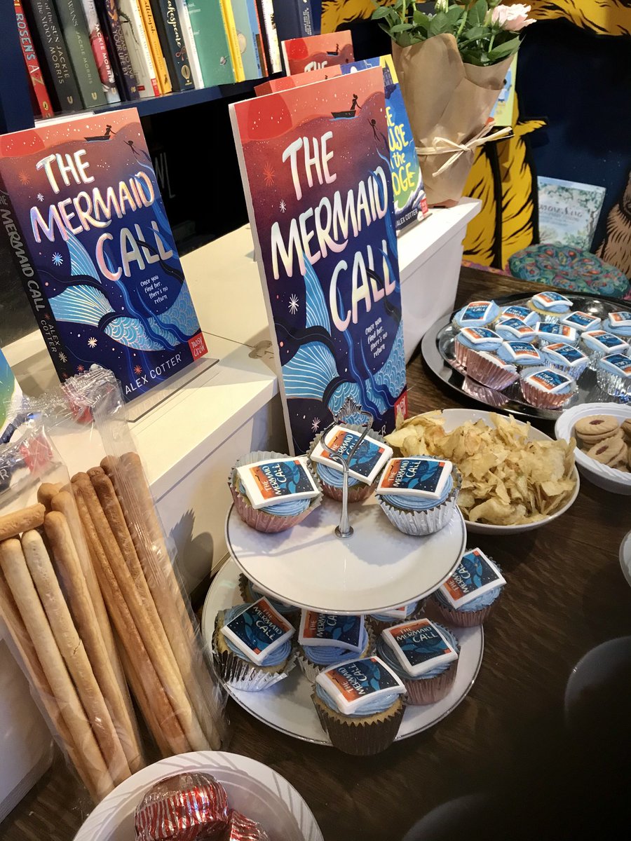 Fantastic launch night #TheMermaidCall by the wonderful ⁦<a href="/AlexFCotter/">Alex Cotter</a>⁩ Fabulous cakes, amazing speeches and the lovely author ⁦<a href="/Hannah_e_Rials/">Hannah is working and just a little writing</a>⁩ running around organising and looking after everyone as always- ⁦<a href="/mrbsemporium/">Mr B's Emporium</a>⁩ #BestbookSellerEver #MG #mermaids