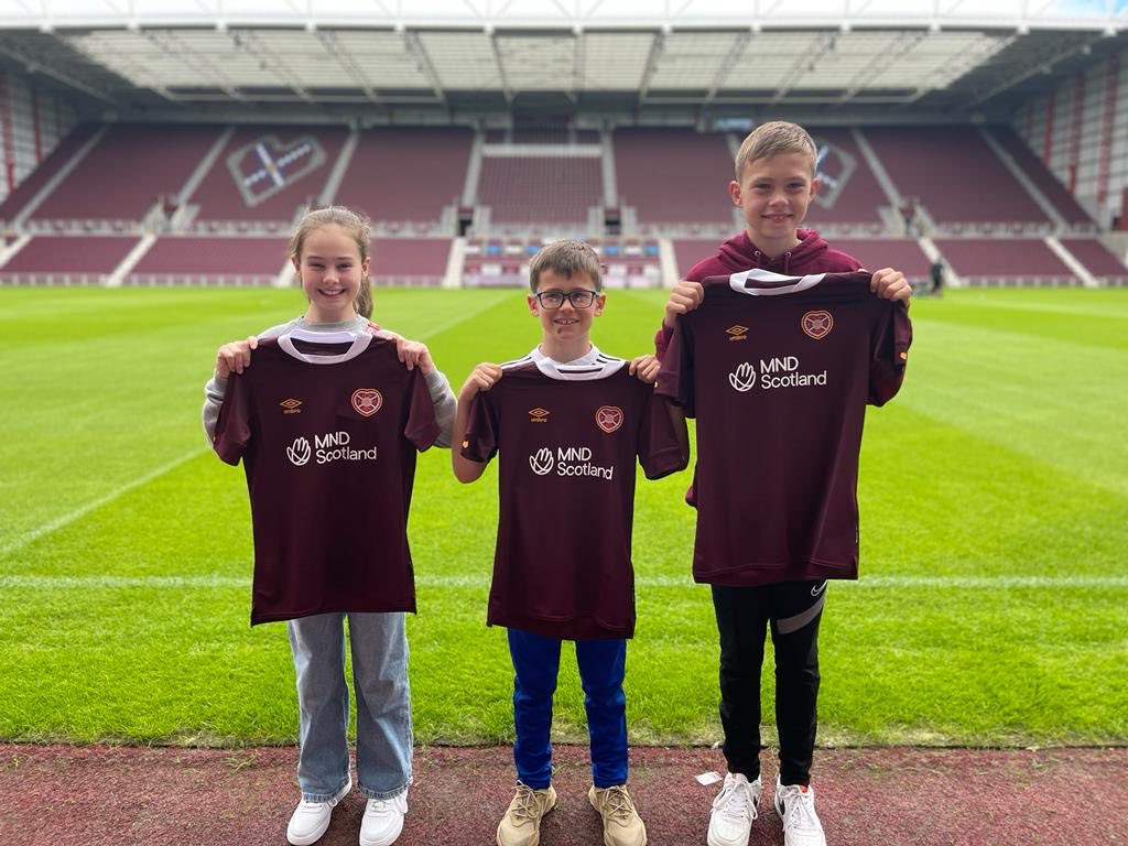 IainMMacleod1's tweet photo. A year on from the launch of the ⁦@JamTarts⁩ and ⁦@MNDScotland⁩ partnership, we were back at Tynecastle today to get our year 2 shirts. Thank you to all at HMFC for the continued support. MND Scotland founders grandchildren happy with the raid on the club shop! https://t.co/mxriwNYN3P