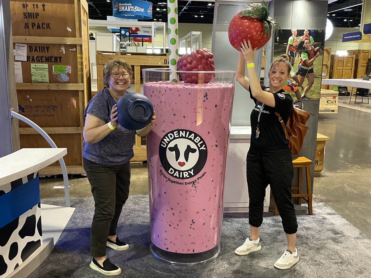 KatieBambacht's tweet photo. Booth set up is a lot more fun than you would think! Who wouldn’t love a picture with a GIGANTIC SMOOTHIE! Stop by ⁦@NtlDairyCouncil⁩ booth #829 at #ANC22 for your pic! 🥛 + 🫐  🍓 https://t.co/NKMPMMQ8tO