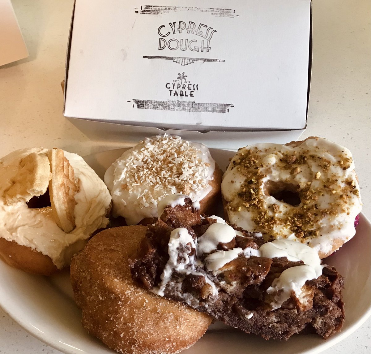 sarkatsha's tweet photo. Invited my neighbors over to help me slay these. Maple eggo, mango rum filled coconut glaze, dragonfruit pudding filled w/pistachio, snickerdoodle, and nutella donut baked french toast. #cypresstable #cypressdough #donuts #fancydonuts #bestneighbor https://t.co/8aucwWcK0v
