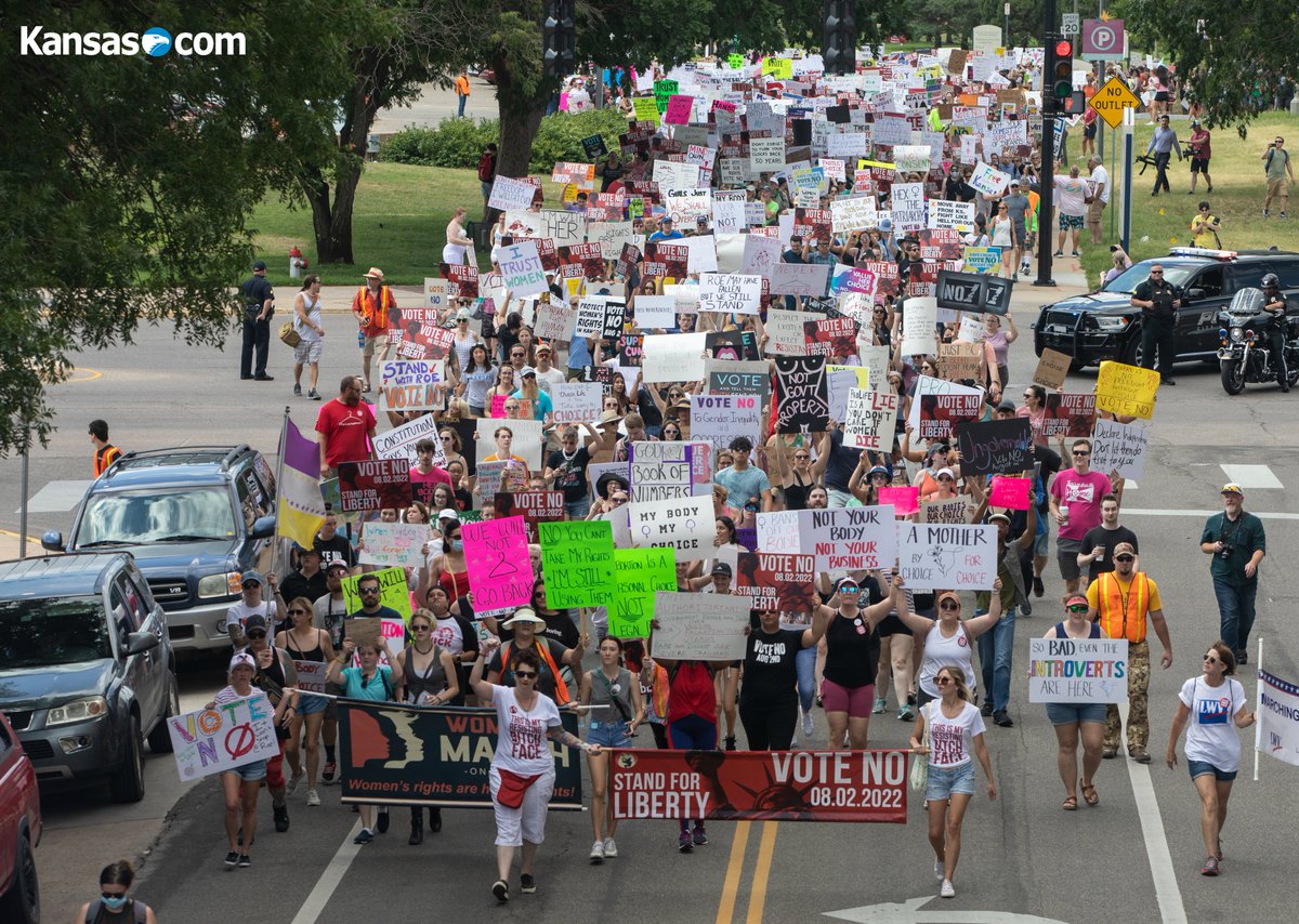 travisheying's tweet photo. Large "Vote No" march through downtown Wichita this morning. A question will appear on the Aug 2 ballot asking Kansans whether or not to give the state legislature control over abortion laws in Kansas. https://t.co/dFDgDfcIRS