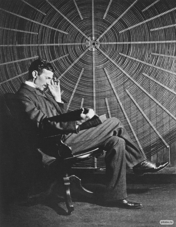 Nikola Tesla, with Roger Boskovich's book, "The Theory of Natural Philosophy", in front of the helical coil of his high-frequency transformer at East Houston St. 46 laboratory, New York. 1896 One of my biggest childhood idols.
