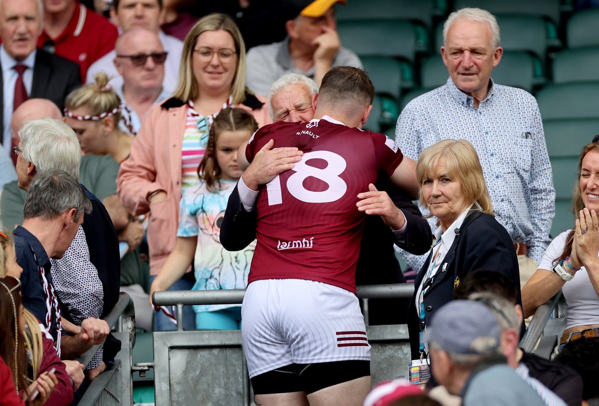 Westmeath goalscorer Kieran Martin embraces Tom Farrell, father of former Westmeath goalkeeper Eoin Farrell who passed away last week