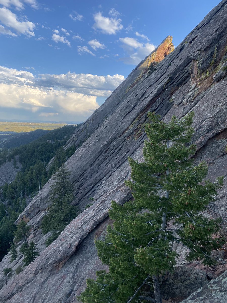 The sun hitting the tip of the 3rd flat iron seen from halfway up the 2nd. 
Boulder, Colorado.
