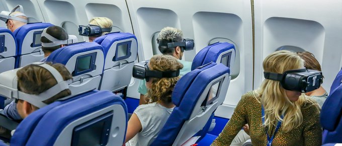 passengers all wearing VR headsets on board an airplane