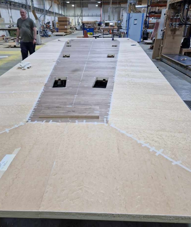 eborcraft's tweet photo. Our bespoke team have been manufacturing this twelve section table. Veneer finishes are Crown cut Walnut and  Birds Eye Maple supported on a black laminate continuous box base. Brass inlay to be added along with soft close hinged flaps and then on to our polishing shop. https://t.co/YzWLvrn8mB