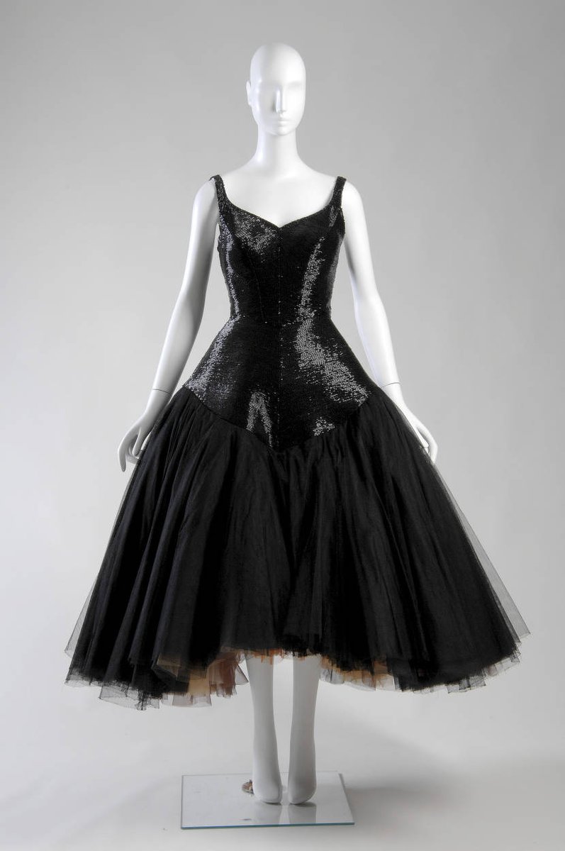LaurenCDeutsch's tweet photo. #Ootd is #CharlesJames's 1952 Infanta cocktail dress. James does not normally use embroidery, but here there are black bugle beads all over a black silk net on top of layers of colored tulle. That's right! When the wearer moved, you would see flashes of orange, pink, and yellow. https://t.co/nYGG9BIHjl