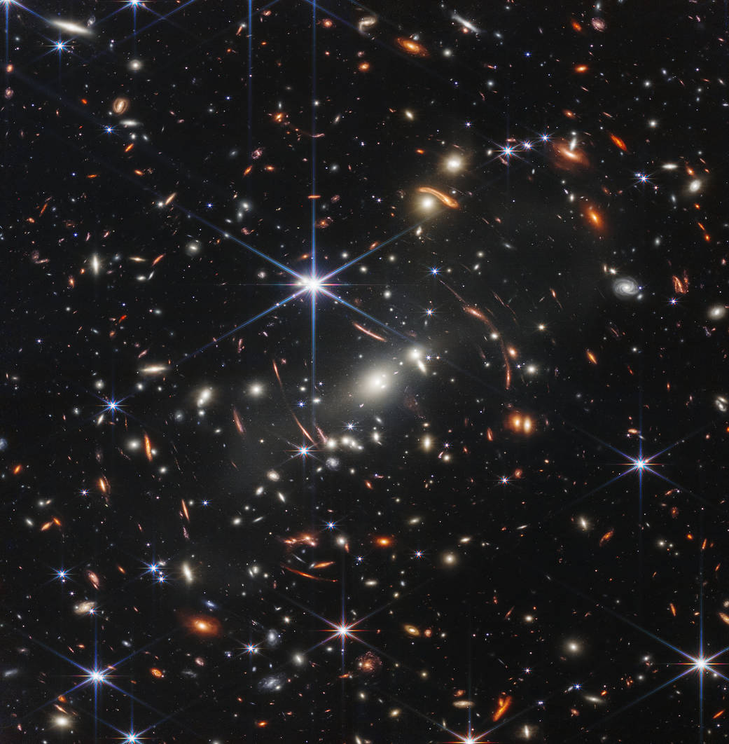 Just Released Deepest-ever view of the cosmos from @NASAWebb. The spiked objects are local stars in our own Galaxy. ignore them. Everything else is an entire galaxy. Many distort into arcs, revealing spacetime curvature from the gravity of a galaxy cluster in the image's center.