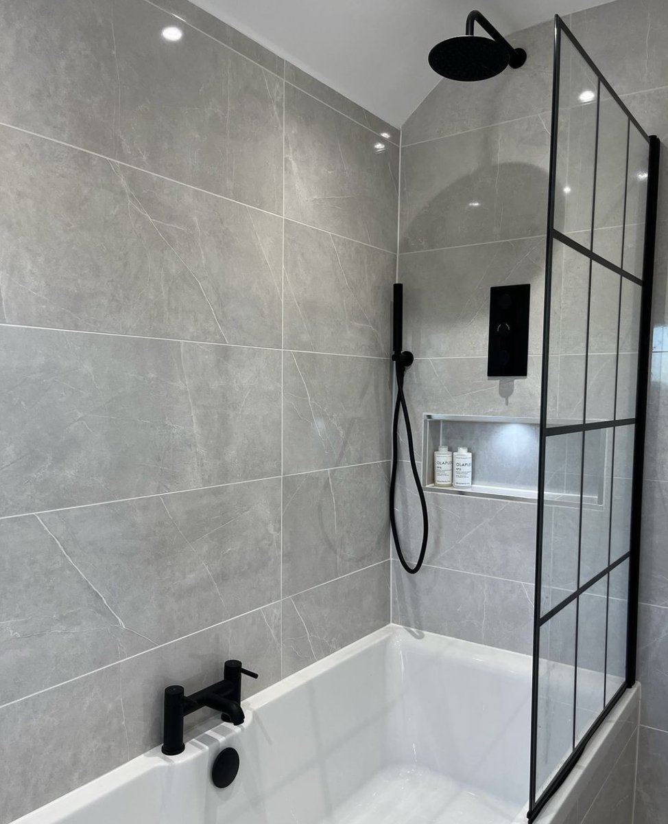 A contemporary wall tile gives a sleek and stylish finish to this bathroom. Perfectly complimenting the bold black fixtures.  Shop the full range of bathroom wall tiles online or in store today!
