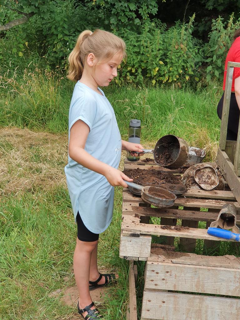 Mud kitchen....someone's in their element!!
