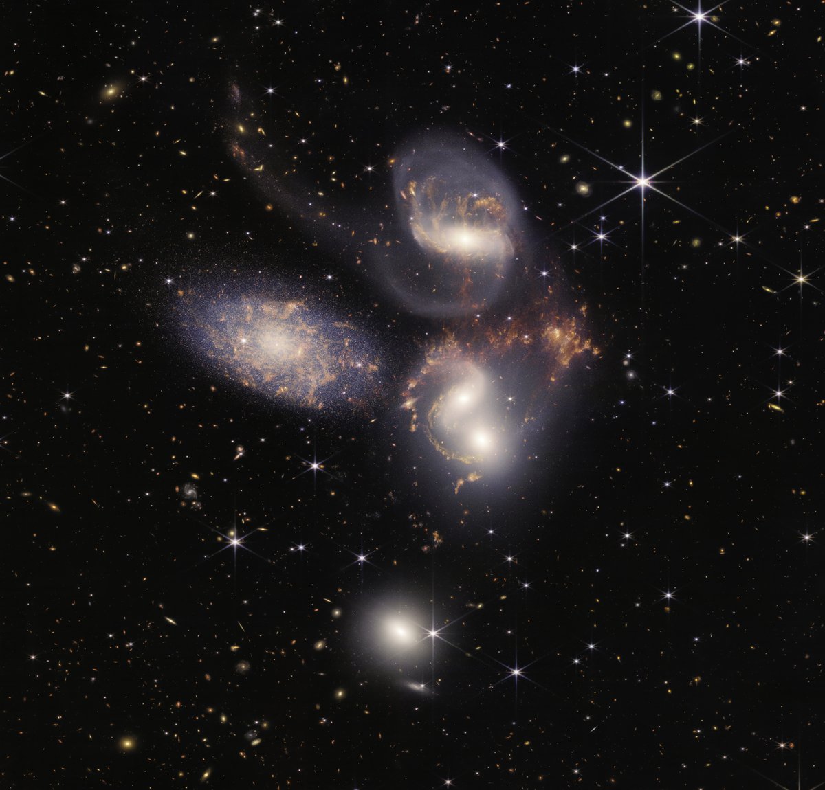 Take Five: Captured in exquisite detail, @NASAWebb peered through the thick dust of Stephan’s Quintet, a galaxy cluster showing huge shockwaves and tidal tails. This is a front-row seat to galactic evolution: nasa.gov/webbfirstimages #UnfoldTheUniverse
