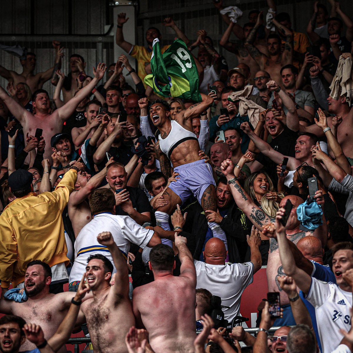 ESPNUK's tweet photo. This photo of Raphinha celebrating with the Leeds fans belongs in a museum 💛 https://t.co/eaqSDaXMWi