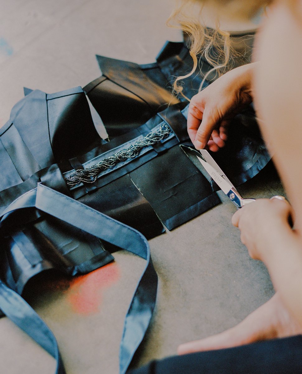 Studio view: creating "Queenmother", a corset bodice with hand-painted Kevlar, leather, silk, and beaded detail, to be worn by Carmen Duarte on July 27, 2022, at Miss Lou: Exhibition One called Soulskins: Fit for Kindred Queens. #kindredqueens #womenartists #fashion #girlsincdc