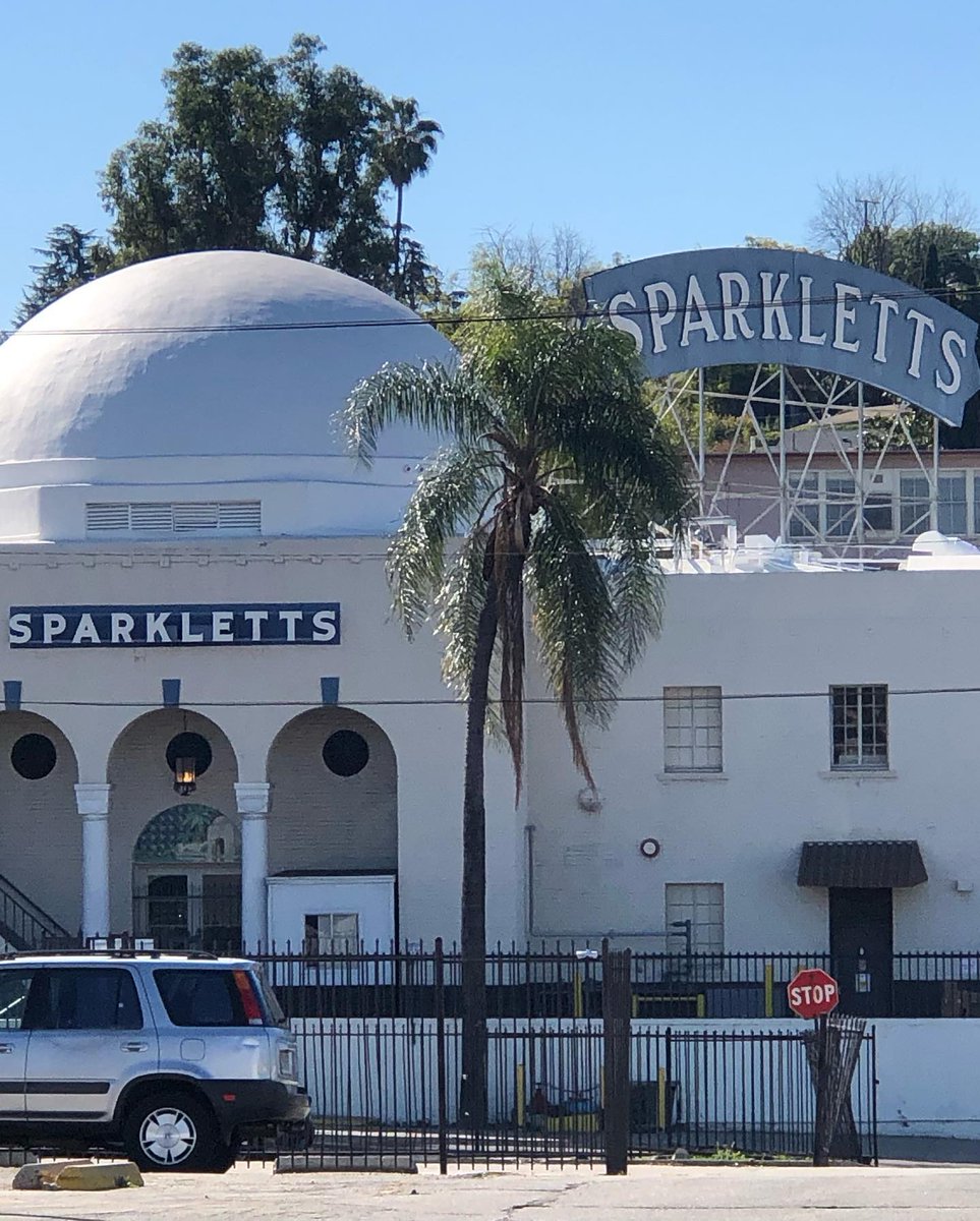 The Sparkling Artesian Water Co. opened in the 1920's in Eagle Rock. It was renamed Sparkletts &amp; by 1929 it broke ground for a larger bottling plant designed by Richard King that still stands today, neon signs &amp; all. 
1929 Image courtesy Hollywood Heritage Historic Photos. com