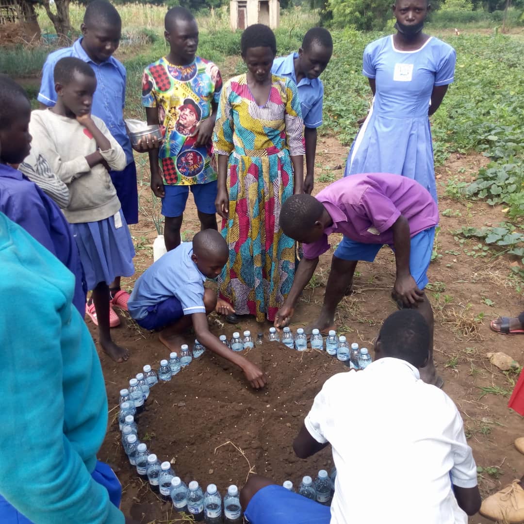 slowfooduganda's tweet image. Kyere Primary School Young Farmers Club members in Serere district learnt how to make gardens using plastic bottles. These were filled with water, tiny holes created at the bottom to release water into the soil in small quantities as a method of irrigation during this dry season.