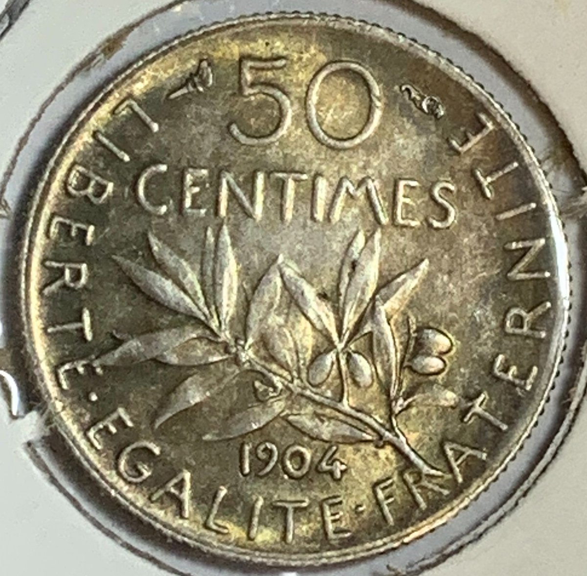 BaltimoreCoins's tweet photo. In honor of #BastilleDay, we are showing French coins all week. This is a 1904 50 #Centime silver #coin. The obverse shows Marianne (national symbol of the French Republic) sowing seeds. The reverse is an olive branch and date. Mintage = 4,000,000. #numismatics #coinclub https://t.co/024WKVDJxD